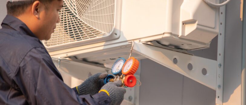 Technician are checking outdoor air conditioner unit,Measuring equipment for filling air conditioners.
