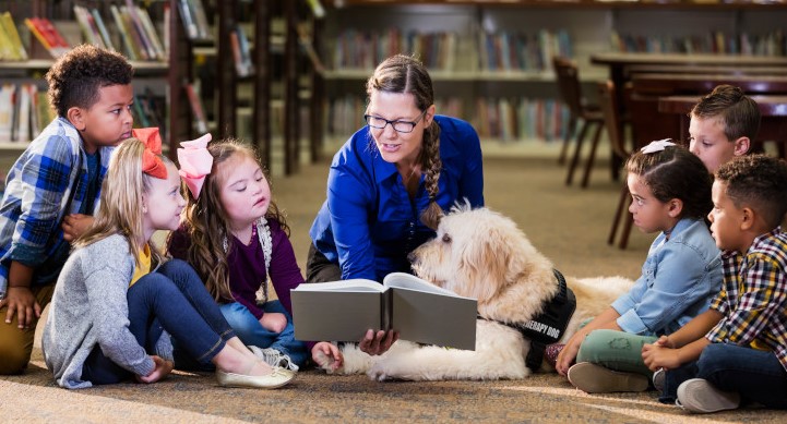 CM Regent blog - Children in library with reading assistance dog