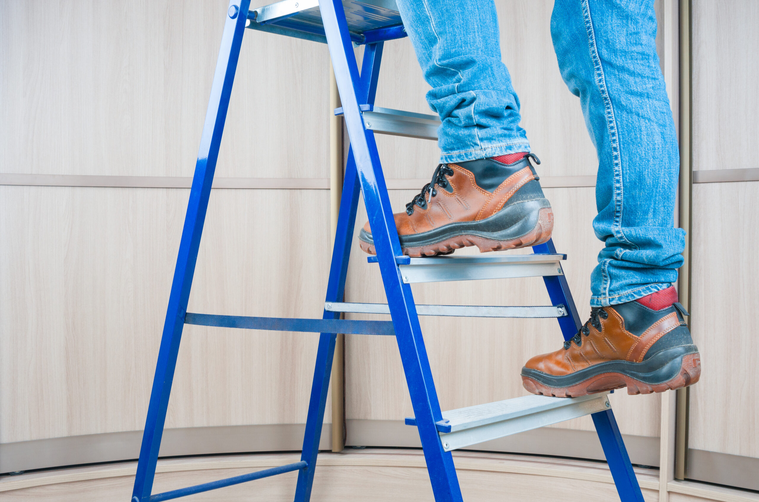 CM Regent blog - Handyman climbing on steel ladder indoor